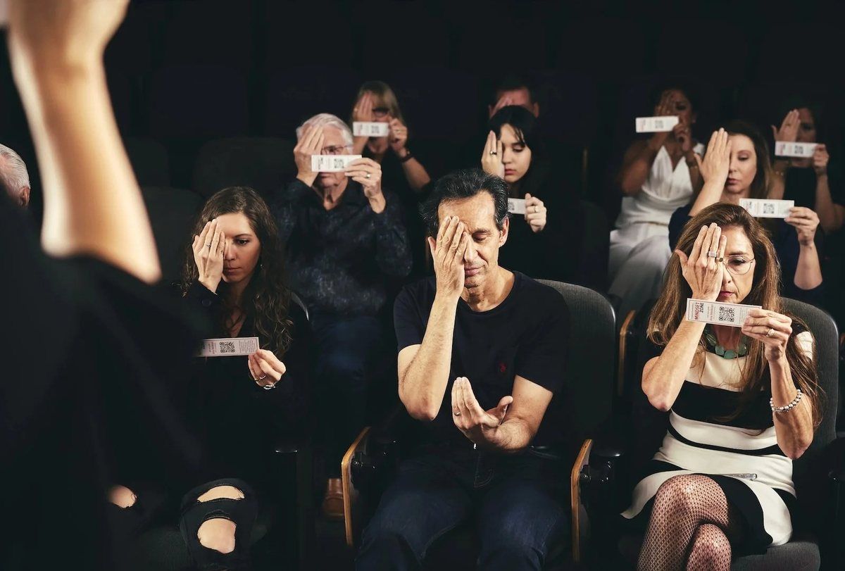 Guests applauding in the live audience at an Icon Experience simulated speaker event.